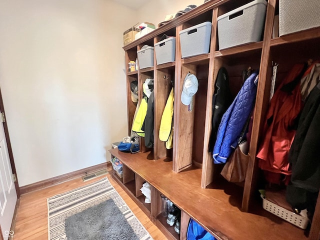 mudroom with baseboards and wood finished floors