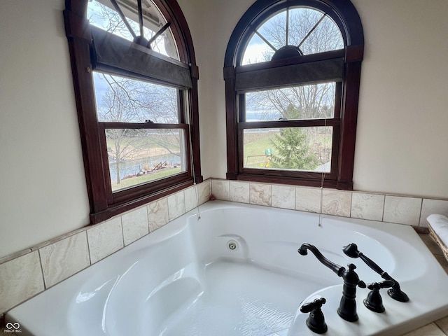 bathroom with a tub with jets