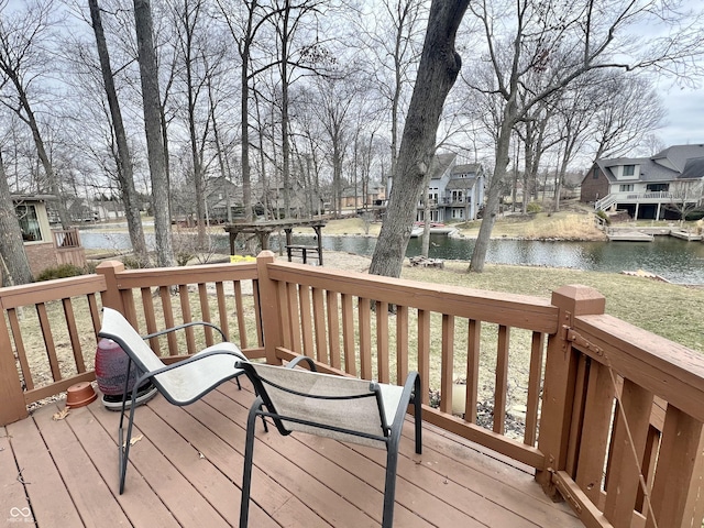 wooden terrace with a residential view and a water view