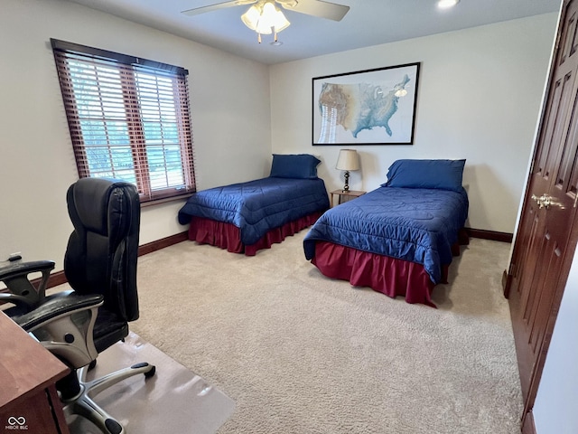 bedroom with a ceiling fan, baseboards, and carpet flooring