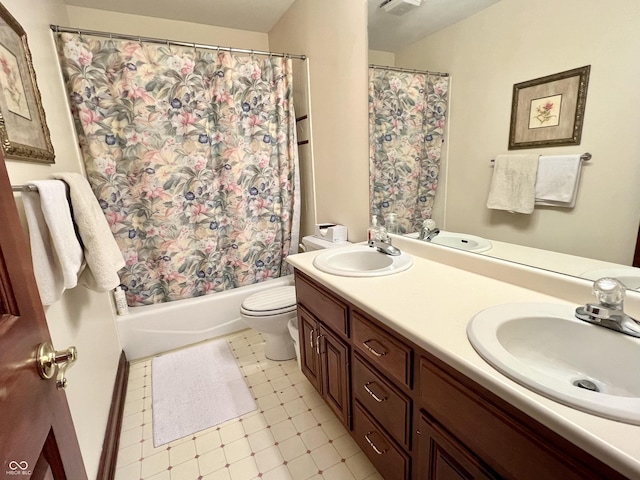 bathroom featuring double vanity, shower / bath combo with shower curtain, a sink, and toilet