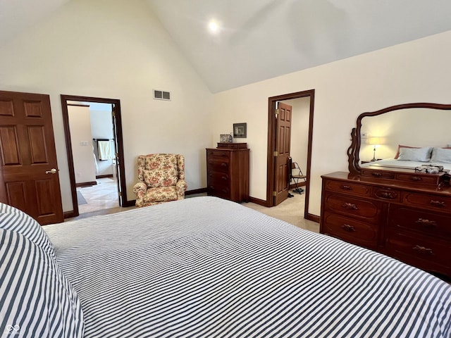 bedroom featuring baseboards, high vaulted ceiling, visible vents, and light colored carpet