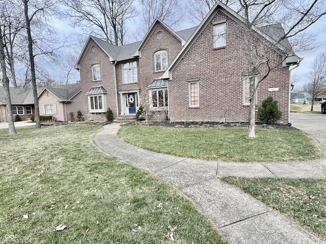 view of front of house with brick siding and a front yard