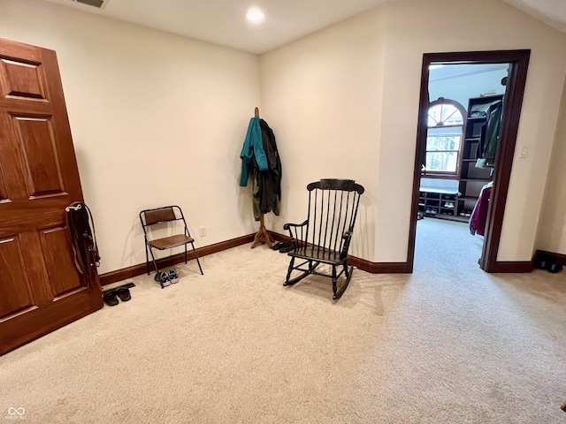 sitting room with baseboards, recessed lighting, and light colored carpet