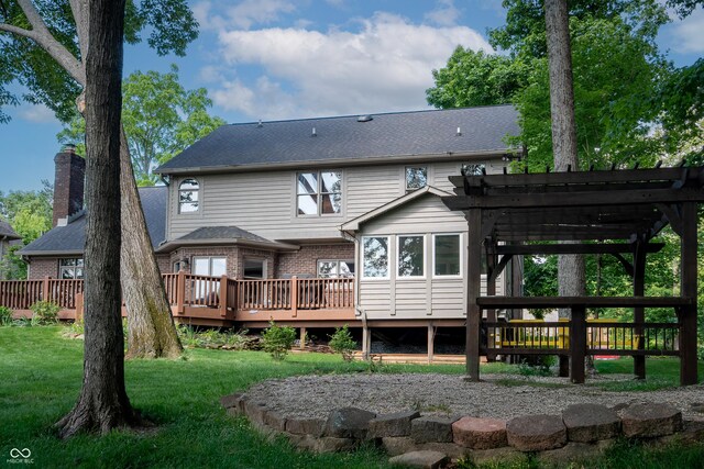 895 Baywood Ct, Columbus, IN 47201 - back of property with a wooden deck, a pergola, brick siding, and a lawn