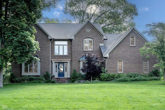 895 Baywood Ct, Columbus, IN 47201 - view of front of house with brick siding, a front lawn, and a shingled roof