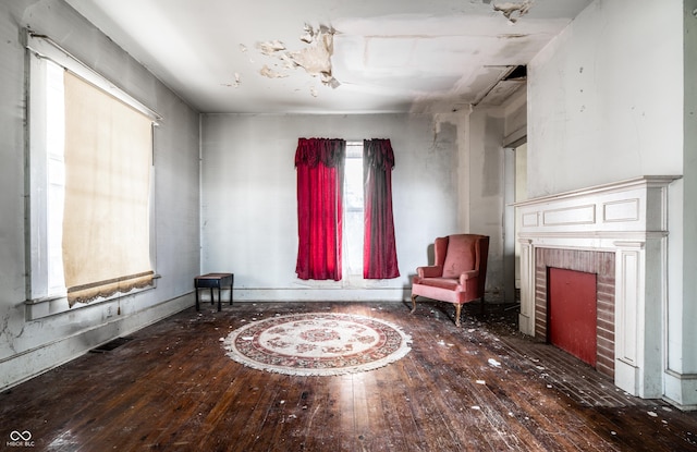 unfurnished room featuring visible vents, a fireplace, and hardwood / wood-style flooring