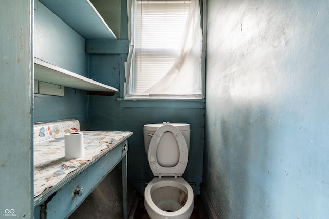 half bath featuring toilet and vanity