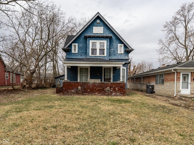 view of front of property featuring covered porch and a front lawn