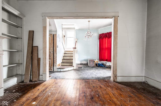 interior space with stairs, hardwood / wood-style flooring, and a chandelier