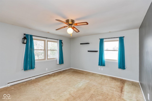 carpeted spare room featuring a ceiling fan, baseboards, and baseboard heating