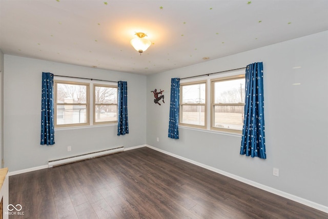 unfurnished room featuring baseboards, a baseboard heating unit, and wood finished floors