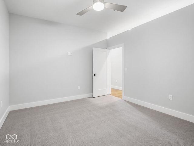 unfurnished room with carpet, baseboards, and a ceiling fan