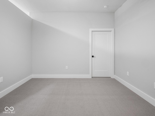 empty room featuring carpet and baseboards