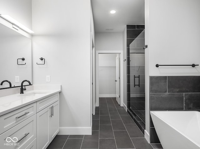 full bathroom featuring visible vents, tile patterned floors, a freestanding bath, vanity, and a shower stall