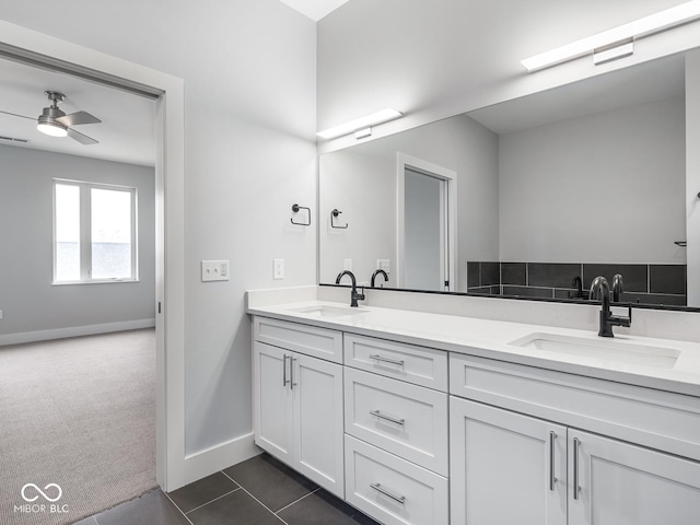 full bath featuring double vanity, ceiling fan, and a sink