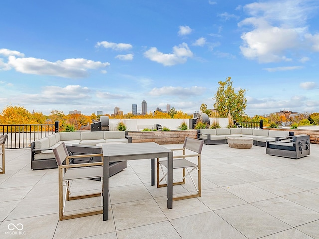 view of patio / terrace featuring an outdoor living space and a city view