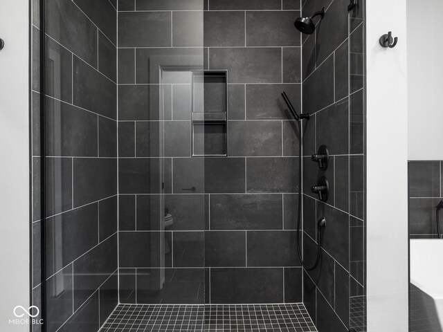 bathroom with a tile shower