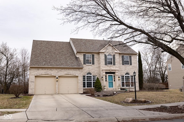 view of front of house featuring a garage, driveway, brick siding, and roof with shingles