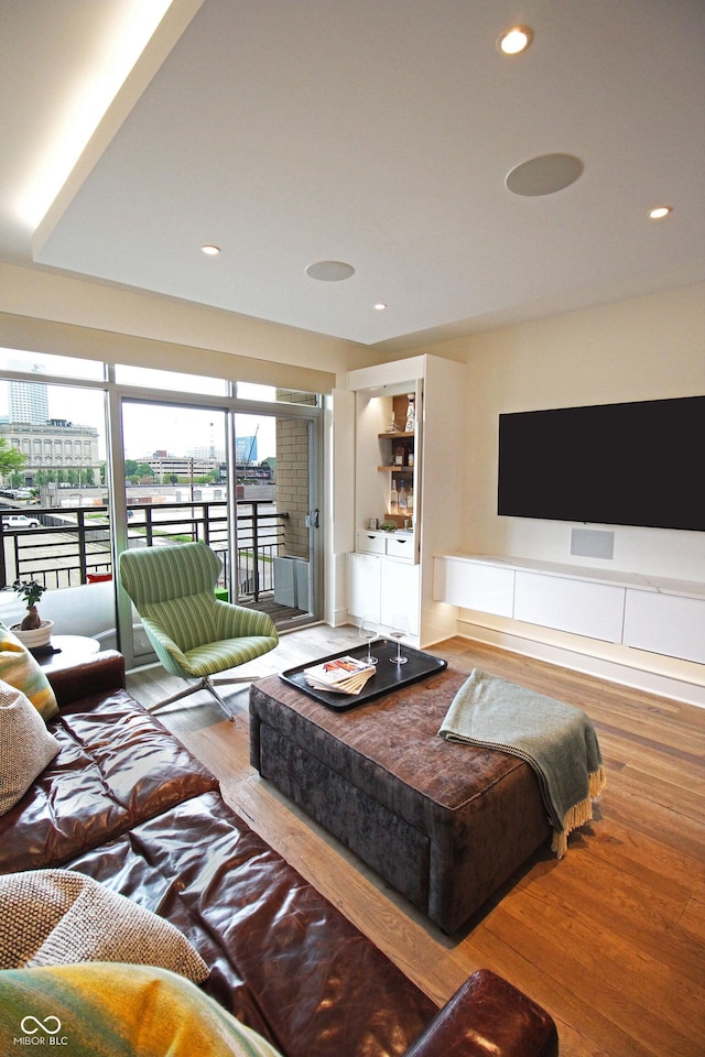 living room featuring washing machine and dryer, wood finished floors, and recessed lighting