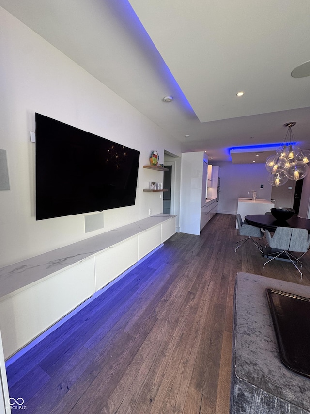 unfurnished living room featuring a chandelier, recessed lighting, and wood finished floors