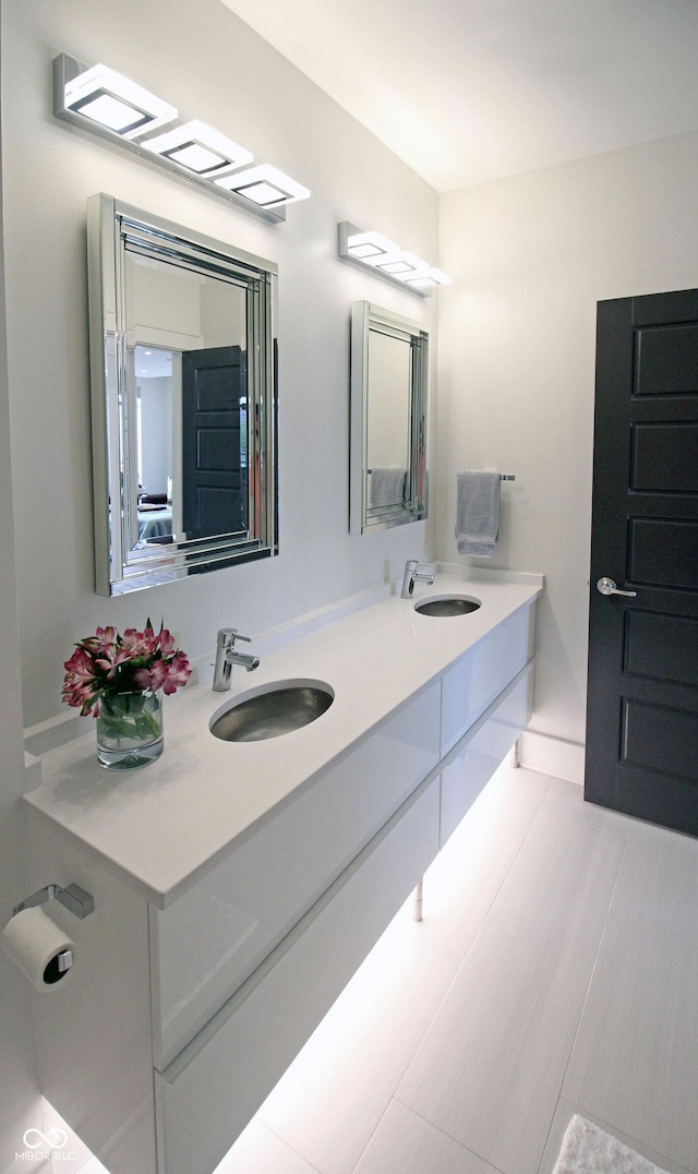 bathroom featuring double vanity and a sink