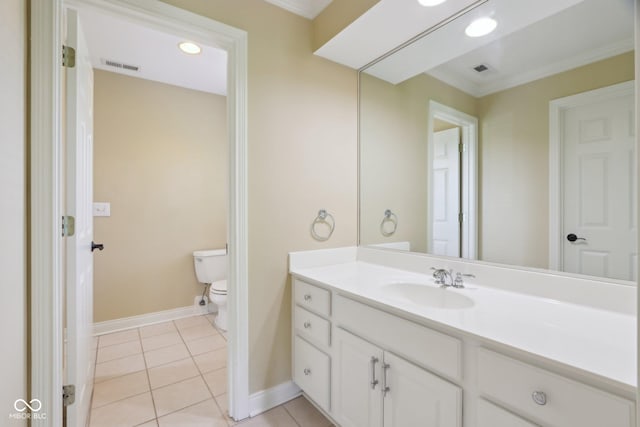 bathroom with toilet, tile patterned flooring, vanity, baseboards, and ornamental molding