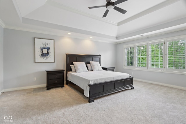 bedroom featuring a raised ceiling, light carpet, crown molding, baseboards, and recessed lighting