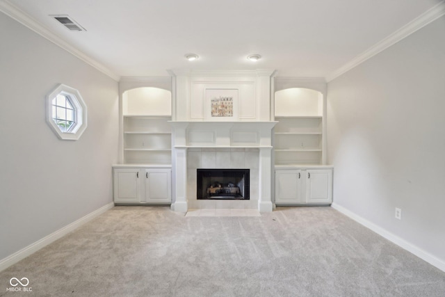 unfurnished living room featuring ornamental molding, baseboards, light carpet, a fireplace, and built in shelves
