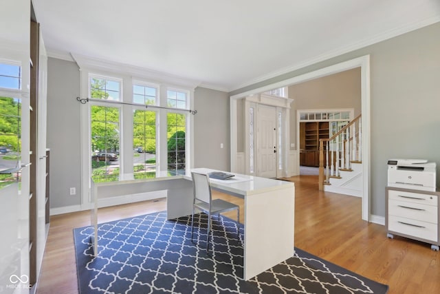 home office featuring ornamental molding, wood finished floors, and baseboards