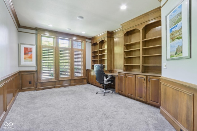 unfurnished office featuring wainscoting, carpet floors, a decorative wall, crown molding, and recessed lighting