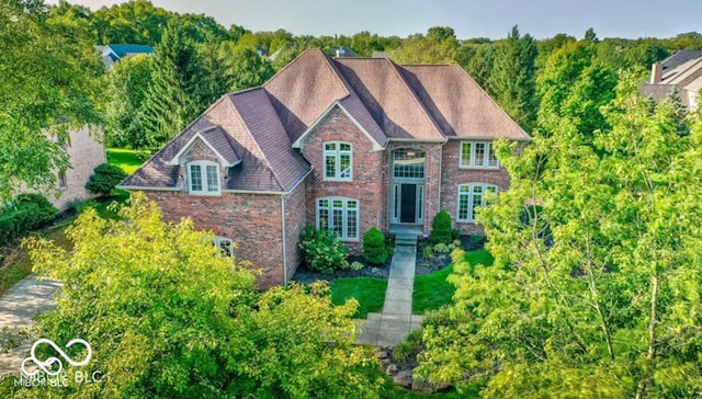 georgian-style home with brick siding and french doors