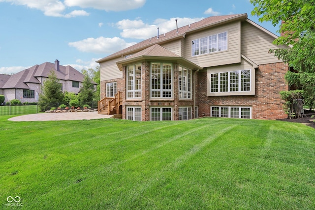 rear view of house featuring a patio and brick siding