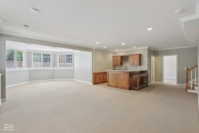 kitchen with light colored carpet, ornamental molding, baseboards, recessed lighting, and light countertops