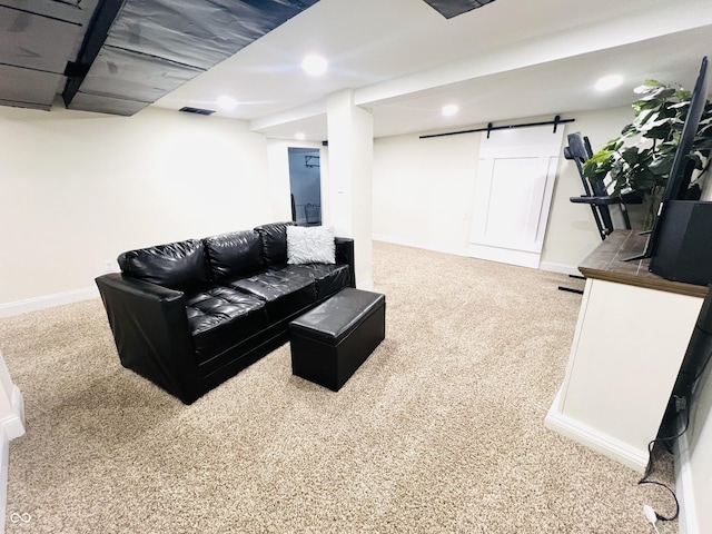 carpeted living room with a barn door, recessed lighting, visible vents, and baseboards