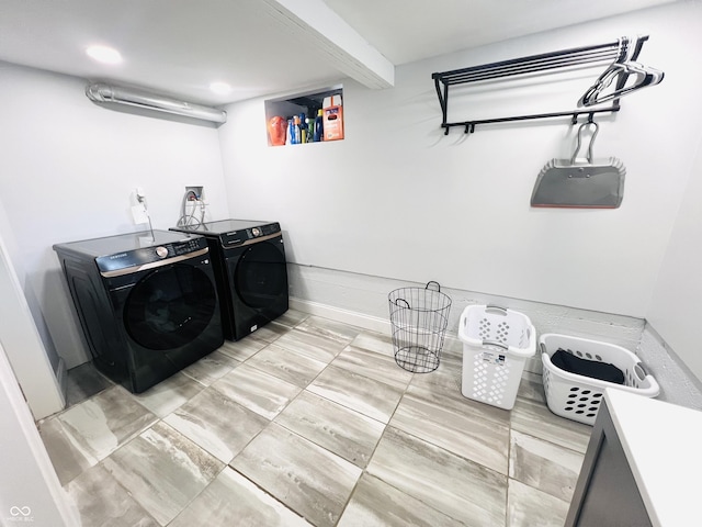 laundry area featuring laundry area, washing machine and clothes dryer, and baseboards