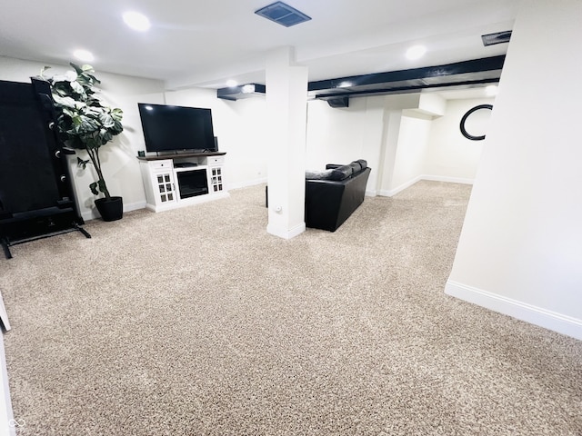 finished basement with visible vents, baseboards, and carpet flooring