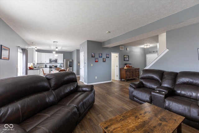 living room featuring a textured ceiling, dark wood-type flooring, and baseboards