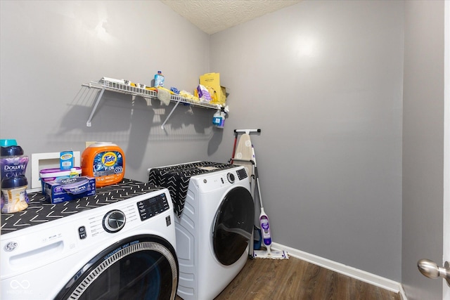 laundry room featuring washer and clothes dryer, dark wood-type flooring, a textured ceiling, laundry area, and baseboards