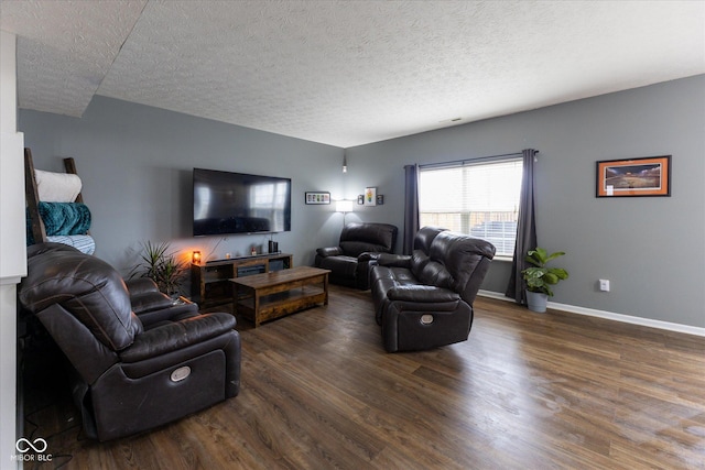 living room featuring a textured ceiling, dark wood-type flooring, visible vents, and baseboards