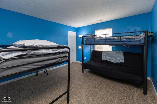 bedroom featuring a textured ceiling, carpet, visible vents, and baseboards