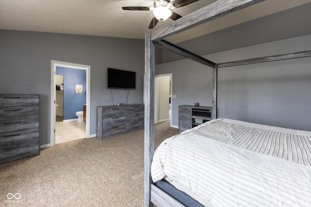 bedroom with a ceiling fan, connected bathroom, baseboards, and carpet flooring