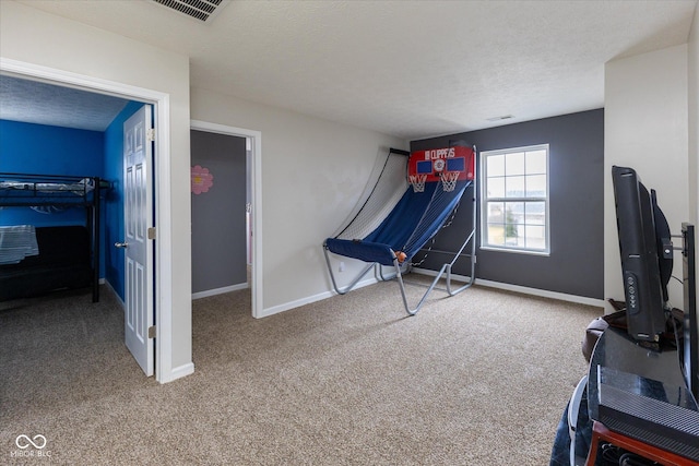 game room with visible vents, carpet flooring, a textured ceiling, and baseboards