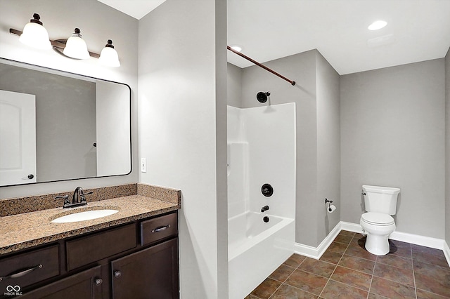 bathroom featuring toilet, vanity, tile patterned flooring, baseboards, and shower / bathtub combination