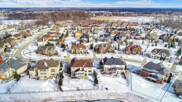 snowy aerial view with a residential view