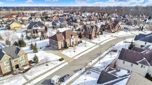 snowy aerial view featuring a residential view