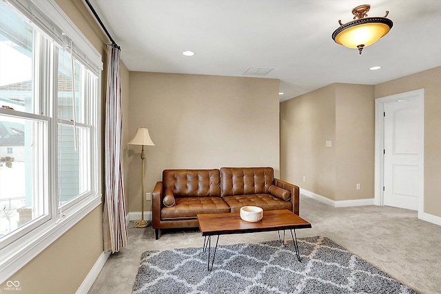 living room with recessed lighting, baseboards, and light carpet