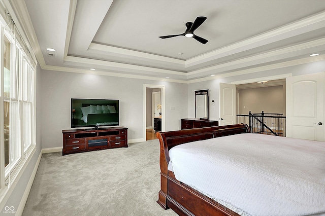 bedroom with baseboards, a raised ceiling, light carpet, and crown molding