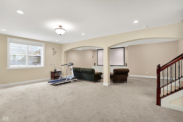 workout room with recessed lighting, carpet, and arched walkways