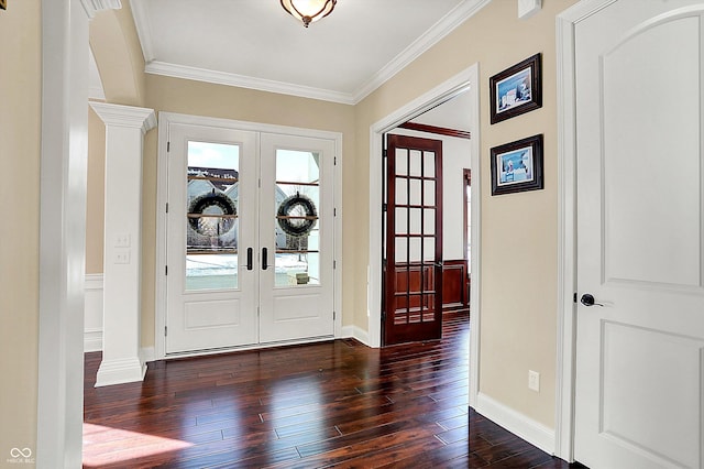 foyer entrance featuring ornamental molding, dark wood-style floors, french doors, decorative columns, and baseboards